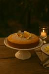 A delicate golden-orange olive oil cake made with almonds, citrus zest, and a subtle glaze, inspired by Provençal flavors.