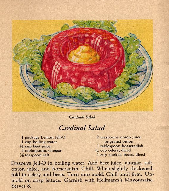 Vintage red Jell-O salad with whipped topping, served in a classic mid-century glass dish.