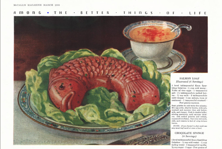A vintage molded salmon loaf shaped like a fish, surrounded by lettuce, featured in the March 1930 issue of McCall’s Magazine using Knox Sparkling Gelatine.