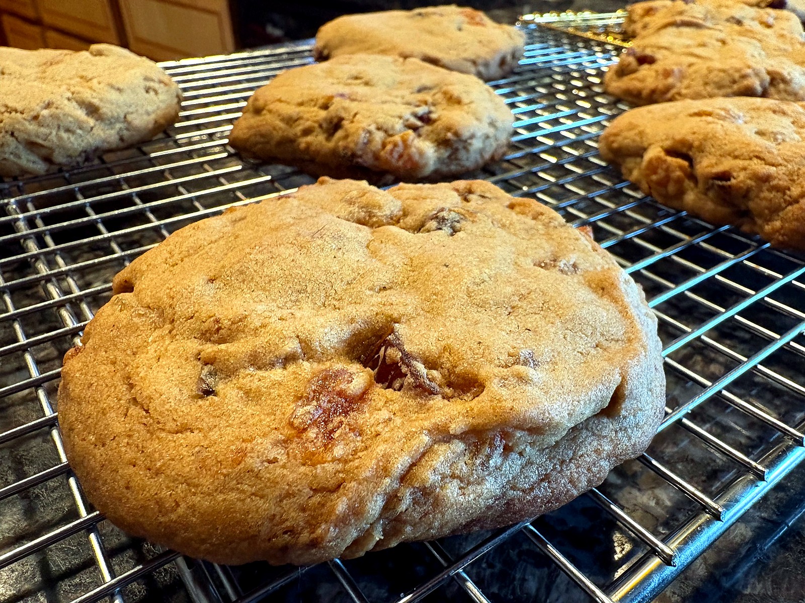 1950s spiced date and apricot drop cookies cooling on a wire rack; golden, crackled tops.