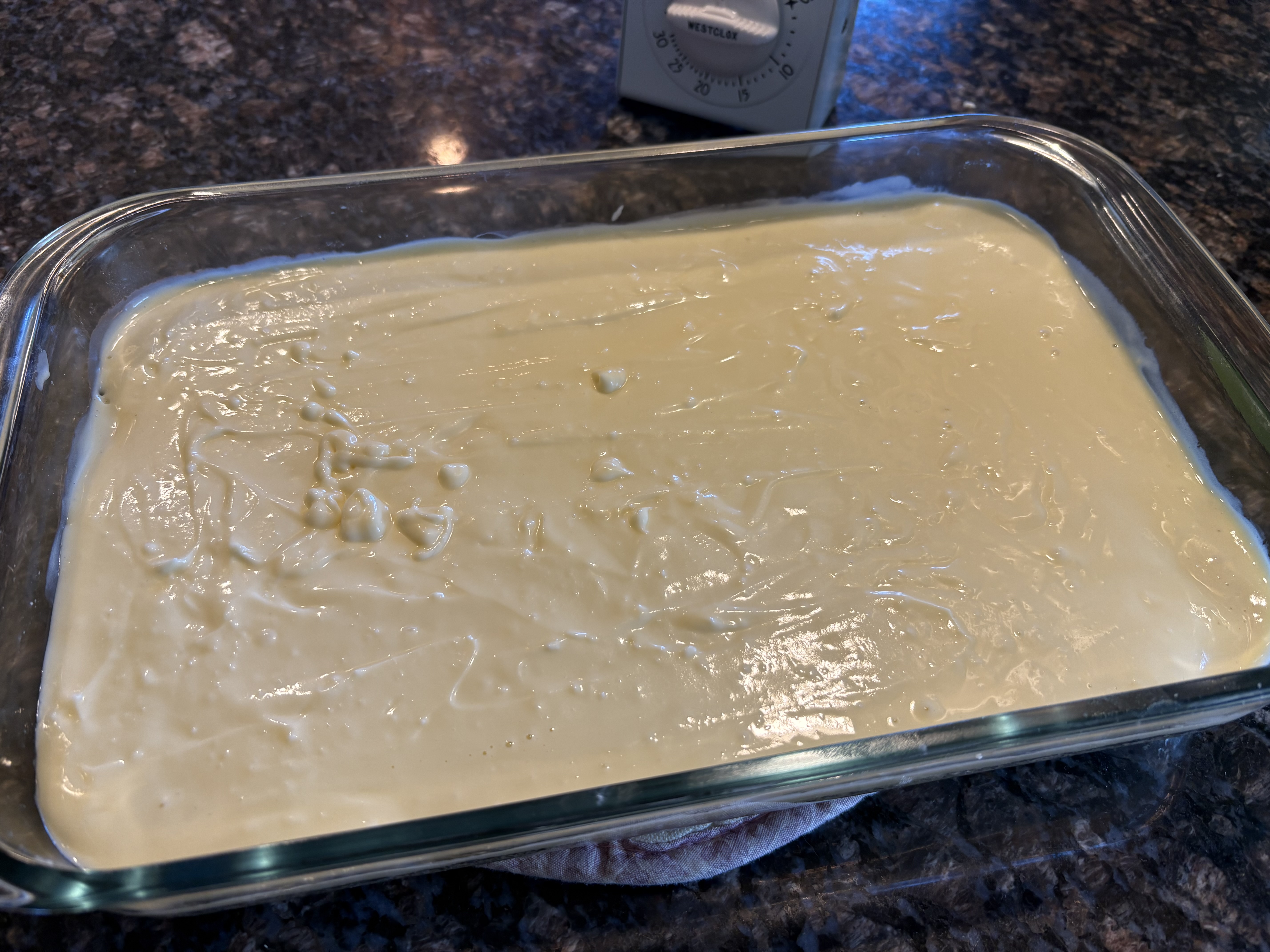 Cream cheese layer smoothed over baked shortbread crust